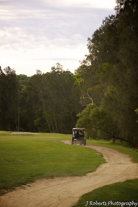 Golf cart in the distance on golf course - wedding photography sydney